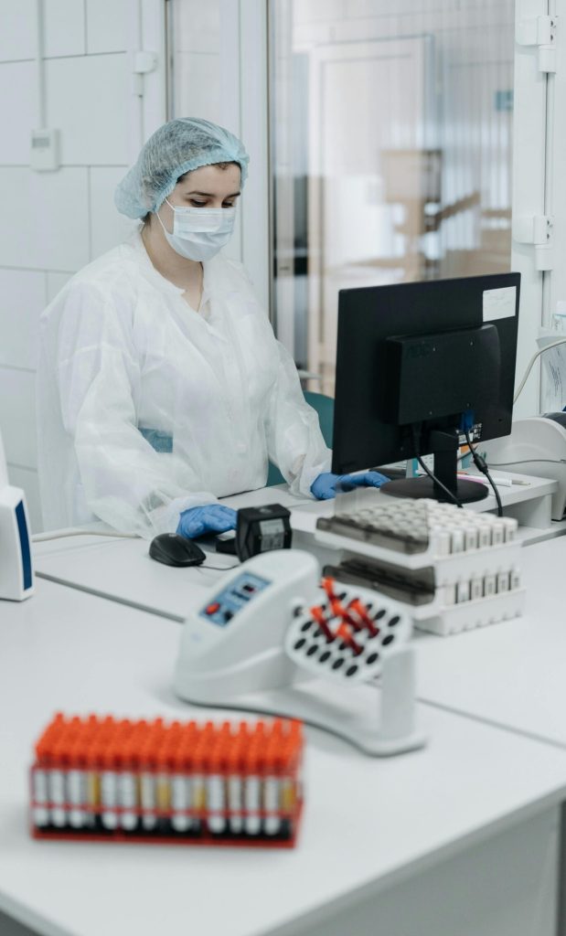 pexels-photo-8442023-8442023 Woman in protective gear analyzing data in a laboratory setting.
